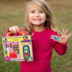 Child holding a sticker book and stickers outdoors
